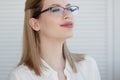 Young business lady in white shirt and glasses. Attractive young woman smiling Royalty Free Stock Photo