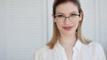 Young business lady in white shirt and glasses. Attractive young woman smiling Royalty Free Stock Photo