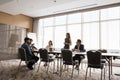 Young business leader woman listening to divers team offers Royalty Free Stock Photo