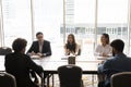 Young business leader woman talking to diverse team of colleagues Royalty Free Stock Photo