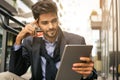 Business man baying over credit card and using iPod. Royalty Free Stock Photo