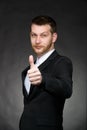 Young business man in black suit with thumbs up Royalty Free Stock Photo