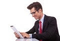 Young business man browsing on his tablet pad Royalty Free Stock Photo