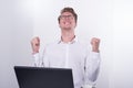 Young business man cheering his success while working on laptop Royalty Free Stock Photo