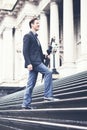 Young business man climbing steps on way to work