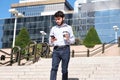 Young business man with a coffee cup in his hand and checking his smartphone walking down stairs Royalty Free Stock Photo