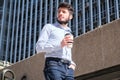 Young business man with a coffee cup in his hand walking down stairs Royalty Free Stock Photo