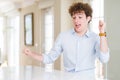 Young business man with curly read head Dancing happy and cheerful, smiling moving casual and confident listening to music Royalty Free Stock Photo