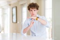 Young business man with curly read head Doing time out gesture with hands, frustrated and serious face Royalty Free Stock Photo