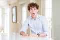 Young business man with curly read head In shock face, looking skeptical and sarcastic, surprised with open mouth Royalty Free Stock Photo