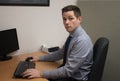 Young Business Man at Desk in Office