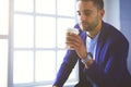 Young business man drinking a cup of coffee or tea Royalty Free Stock Photo