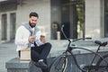 Young business man eating his lunch outdoors Royalty Free Stock Photo