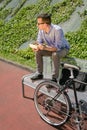 Young business man eating at lunch break outdoors Royalty Free Stock Photo