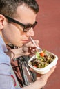 Young business man eating at lunch break outdoors Royalty Free Stock Photo