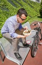 Young business man eating at lunch break outdoors Royalty Free Stock Photo