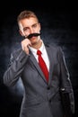 Young business man with fake mustaches Royalty Free Stock Photo