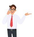 Young business man in formal speaking or talking on the mobile, cell or smart phone. Male person showing, presenting or pointing. Royalty Free Stock Photo