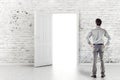 Young business man in front of an open door Royalty Free Stock Photo