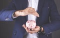 Young business man hand holding piggy bank Royalty Free Stock Photo