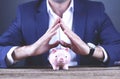 Young business man hand holding piggy bank Royalty Free Stock Photo