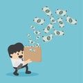 Young business man happy with the money coming in his box. Royalty Free Stock Photo