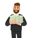 Young business man holding bundle of cash or dollar. Person carrying pile of money, currency notes. Male character design.