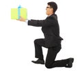 Young Business man holding a gift box and kneel.