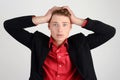 Young business man holding his head frowning with worry. Royalty Free Stock Photo