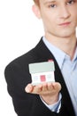 Young business man holding house model Royalty Free Stock Photo