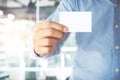 Young business man holding white business card