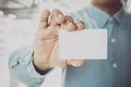 Young business man holding white business card on modern office Royalty Free Stock Photo