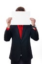 Young business man holds paper before the head.