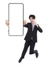 Young business man jumping and showing blank mobile phone screen Royalty Free Stock Photo