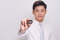 A young business man model holds a bitcoin gold coin