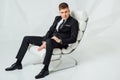 Young business man in modern suit sitting on chair Royalty Free Stock Photo