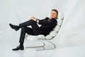 Young business man in modern suit sitting on chair Royalty Free Stock Photo