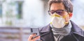 Flue and corona safety concept. Business man wearing face mask to protect himself and using smartphone. Outdoors