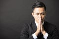 Young business man with pray gesture