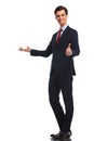 Young business man presenting and making the ok sign Royalty Free Stock Photo