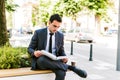 Young Business Man Reading Book While Drinks Coffee Outdoor Royalty Free Stock Photo