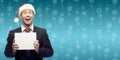 young business man in santa hat holding sign over winter background Royalty Free Stock Photo