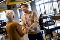 Young business man and senior business woman shaking hands in the office Royalty Free Stock Photo