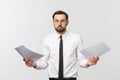 Young business man serious writing on clipboard, Handsome businessman wear elegant suit and tie isolated over white Royalty Free Stock Photo