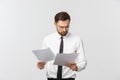 Young business man serious writing on clipboard, Handsome businessman wear elegant suit and tie isolated over white Royalty Free Stock Photo