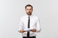 Young business man serious writing on clipboard, Handsome businessman wear elegant suit and tie isolated over white Royalty Free Stock Photo