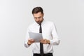 Young business man serious writing on clipboard, Handsome businessman wear elegant suit and tie isolated over white Royalty Free Stock Photo