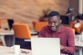 Young business man with a shocked expression working on a laptop Royalty Free Stock Photo