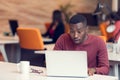 Young business man with a shocked expression working on a laptop Royalty Free Stock Photo