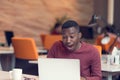 Young business man with a shocked expression working on a laptop Royalty Free Stock Photo